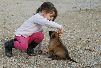 Image showing little girl and puppy