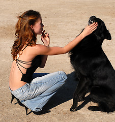 Image showing girl and black dog