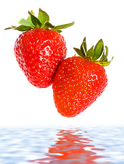 Image showing fresh ripe strawberries falling in water