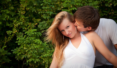 Image showing man kiss sly girl in cheek