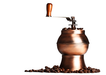 Image showing vintage coffee grinder standing on beans