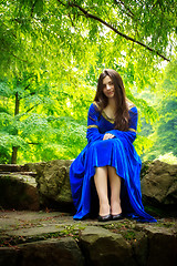 Image showing medieval girl sitting on stone stage