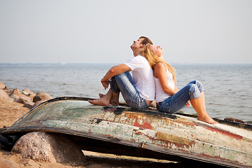 Image showing couple sitting on old boat
