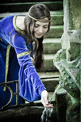 Image showing medieval girl next ancient spring