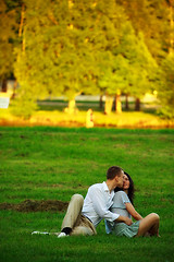 Image showing young couple sitting on park lawn