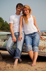 Image showing couple on a beach near old boat