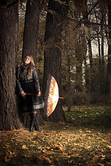 Image showing girl with umbrella in autumn park