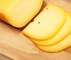 Image showing cheese slices on cutting board