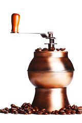 Image showing vintage coffee grinder standing on beans