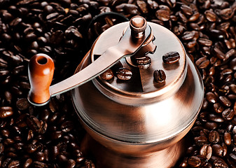 Image showing vintage coffee mill in beans