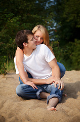 Image showing couple sitting on a sand