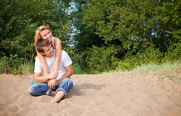 Image showing couple sitting on a sand