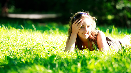 Image showing beautiful girl laying on meadow