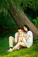 Image showing young couple sitting under tree