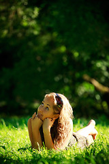 Image showing girl laying on sunny meadow