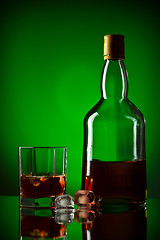 Image showing whiskey bottle, ice and glass