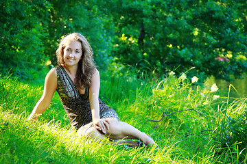 Image showing beautyful woman sitting on riverside