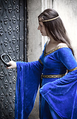 Image showing medieval girl opening door