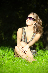 Image showing beautiful girl sitting in grass