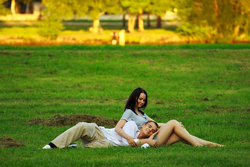 Image showing couple laying on park lawn