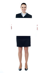 Image showing Caucasian businesswoman holding a blank billboard