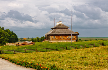 Image showing wooden cottage on green hill