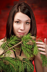 Image showing beautiful girl with pine branch