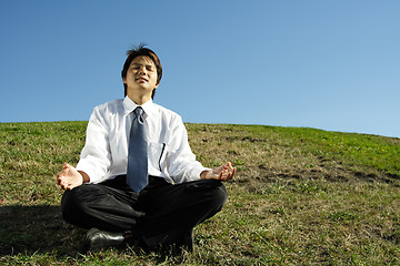 Image showing Businessman meditating