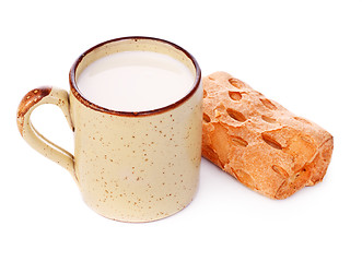 Image showing Crispy Bun and Mug of Milk