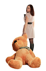 Image showing beautiful girl draging toy bear