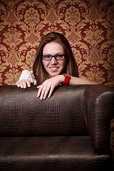 Image showing girl peeping out from sofa