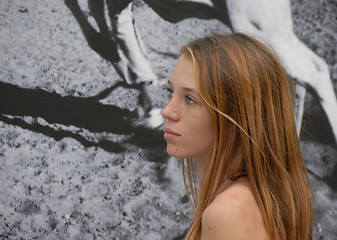 Image showing teen watching a poster