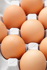 Image showing brown eggs in box