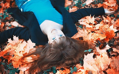 Image showing Girl Lying in Autumn Leaves