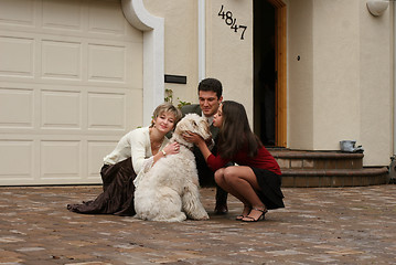 Image showing Happy family with a dog
