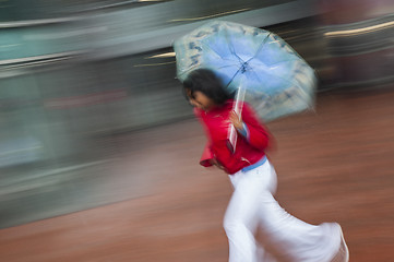 Image showing Girl running with umbrella