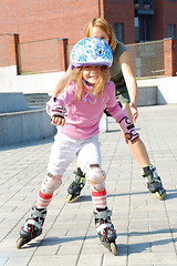 Image showing city park family rolleblading on roller skates together