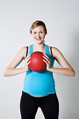 Image showing Pregnant woman holding an exercise ball