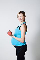 Image showing Pregnant woman exercising with dumbbells