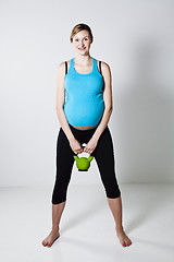 Image showing Pregnant woman exercising with kettlebell