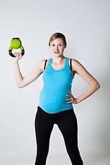 Image showing Pregnant woman exercising with kettlebell