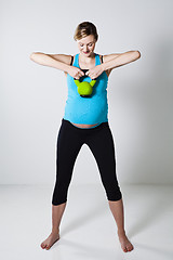 Image showing Pregnant woman exercising with kettlebell