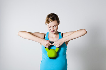 Image showing Pregnant woman exercising with kettlebell