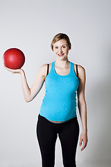 Image showing Pregnant woman exercising with exercise ball