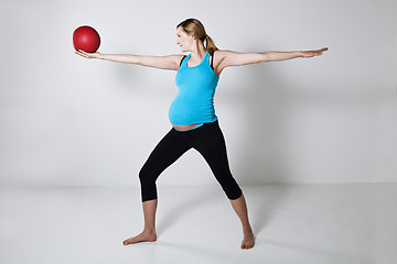 Image showing Pregnant woman exercising with exercise ball