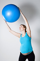 Image showing Pregnant woman exercising with fitness ball