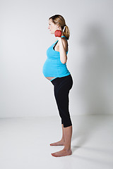 Image showing Pregnant woman exercising with dumbbells