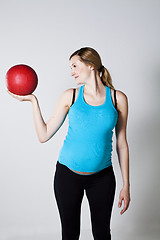 Image showing Pregnant woman exercising with exercise ball