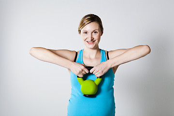 Image showing Pregnant woman exercising with kettlebell