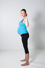 Image showing Pregnant woman exercising with dumbbells